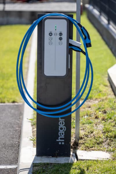 Borne de recharge électrique avec câble bleu.